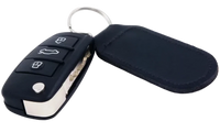 Car key fob with remote control and black case on a white background
